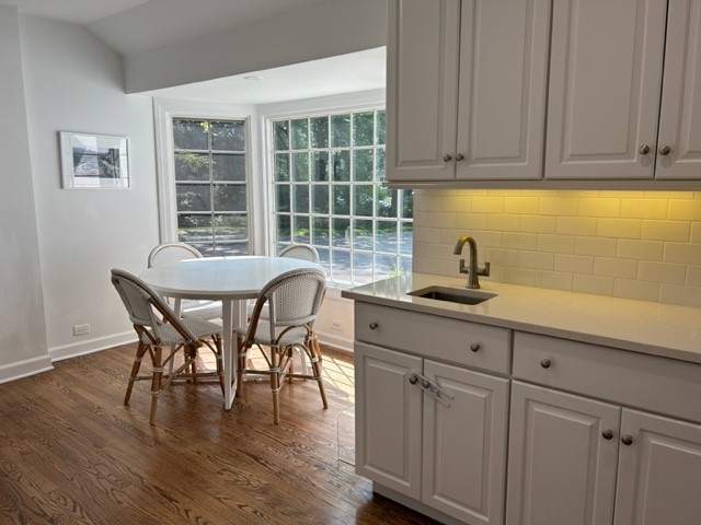269 Locust Road Winnetka, IL 60093 - Photo 7 of 26 a kitchen with granite countertop a table chairs sink and cabinets