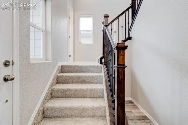 a view of entryway and hall with wooden floor