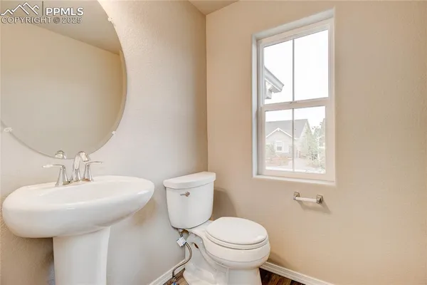 a bathroom with a sink a toilet and a window