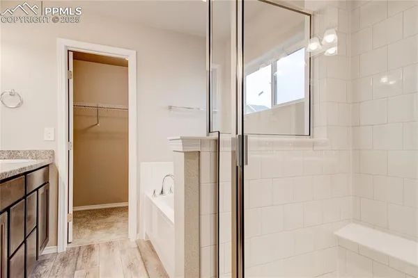 a bathroom with a tub and shower