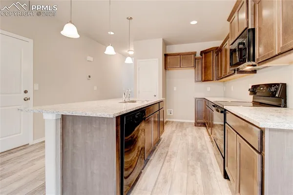 a kitchen with stainless steel appliances a sink stove and cabinets