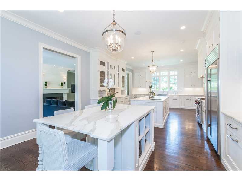 12 Shady Acres Road Darien, CT 06820 - Photo 2 of 8 a kitchen view with stainless steel appliances kitchen island granite countertop a table chairs and a refrigerator