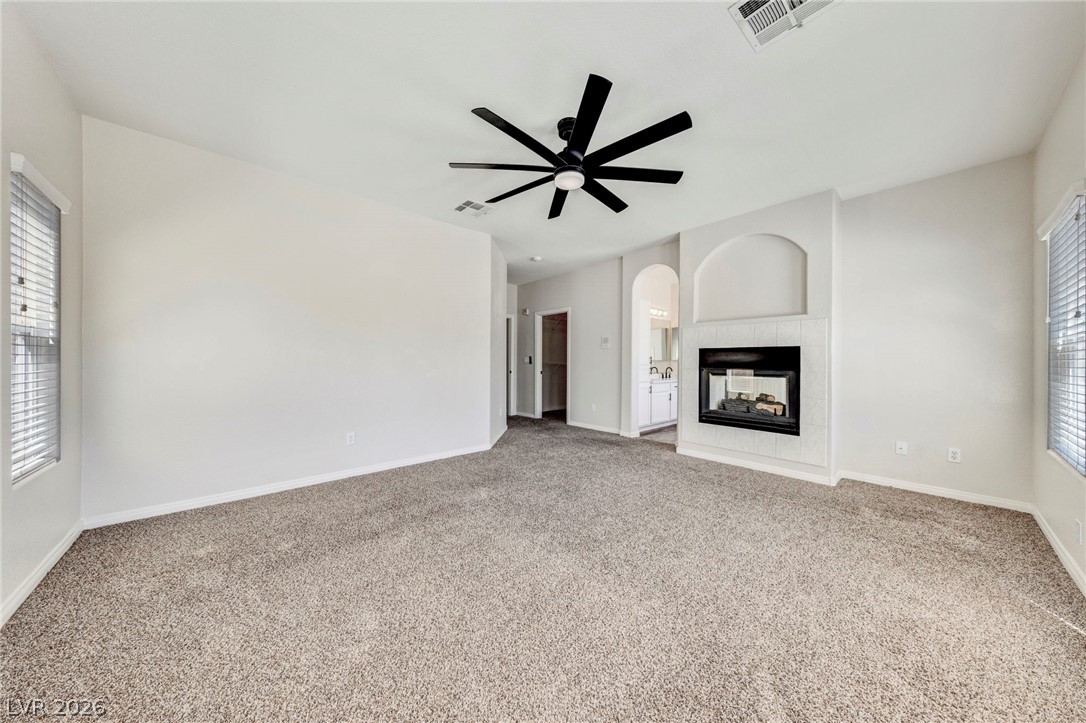 740 Aldo Rae Court, Unit NONE Henderson, NV 89052 - Photo 24 of 35 A spacious room offers comfortable carpet flooring and a corner fireplace for inviting evenings.