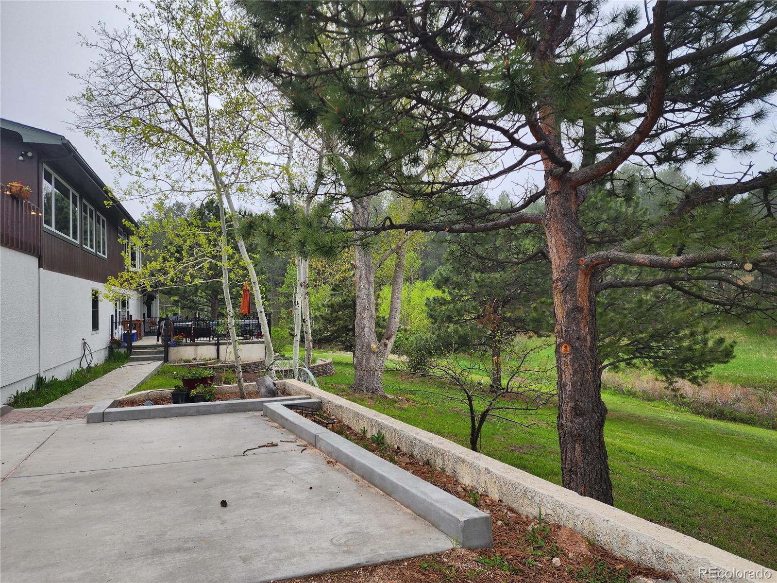 18475 West Road Monument, CO 80132 - Photo 2 of 25 a garden with trees in the background