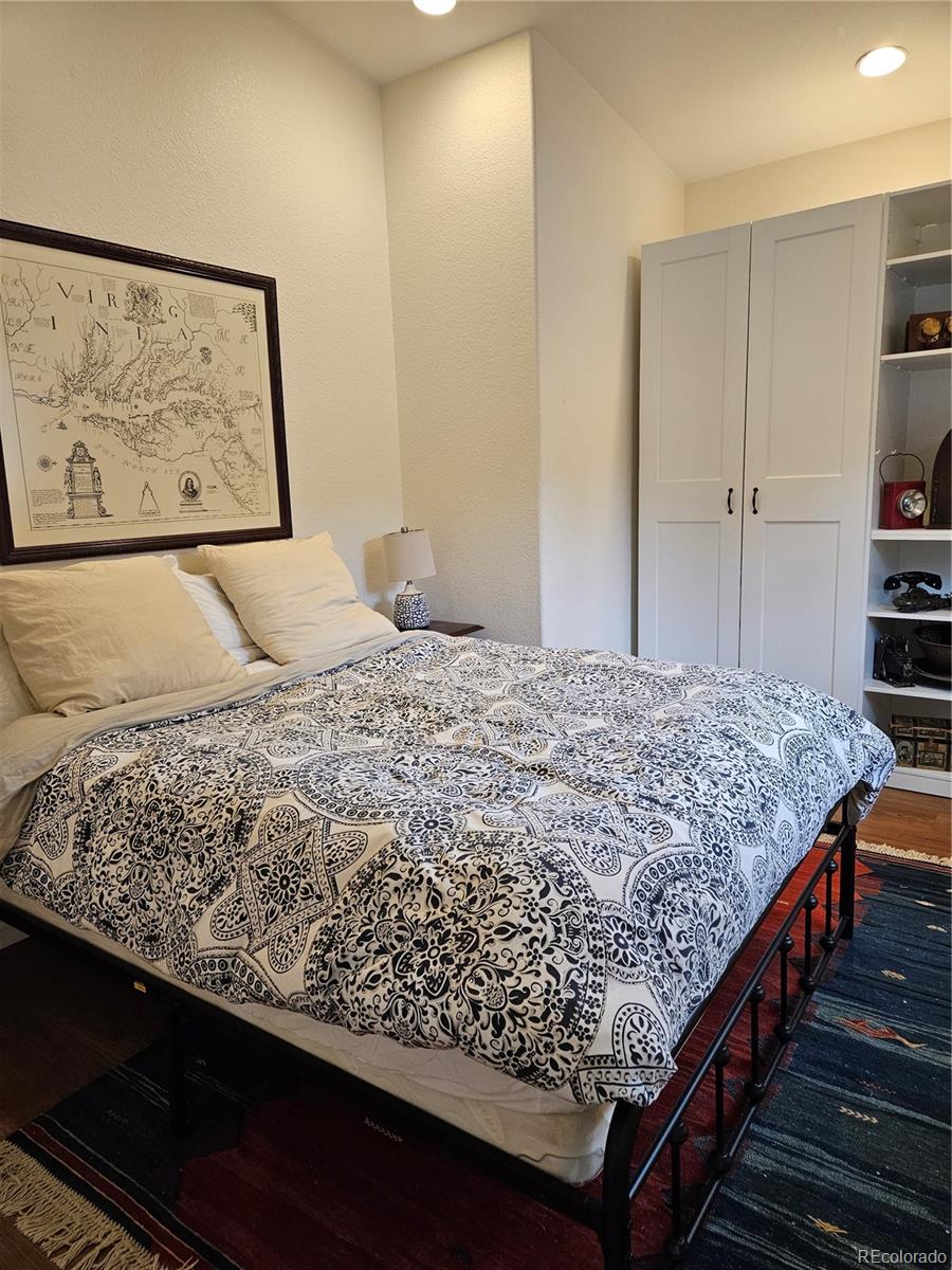18475 West Road Monument, CO 80132 - Photo 9 of 25 a bedroom with a bed and painting on the wall