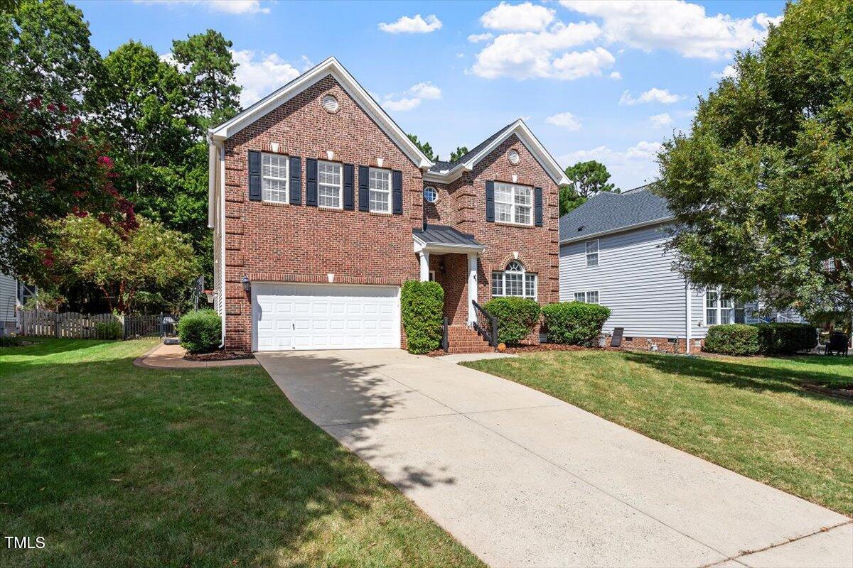308 Mickleson Ridge Drive Raleigh, NC 27603 - Photo 2 of 51 a front view of a house with a yard and garage
