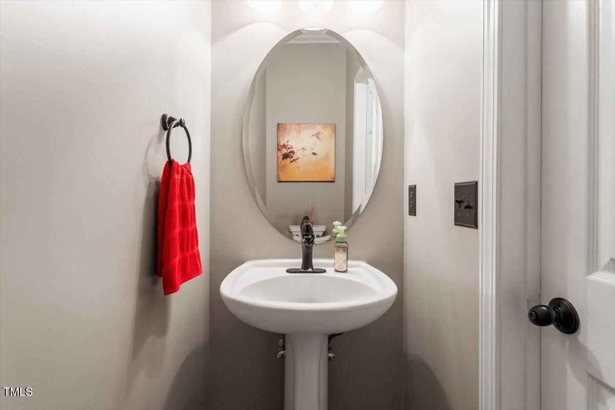 308 Mickleson Ridge Drive Raleigh, NC 27603 - Photo 22 of 51 a bathroom with a sink and a mirror