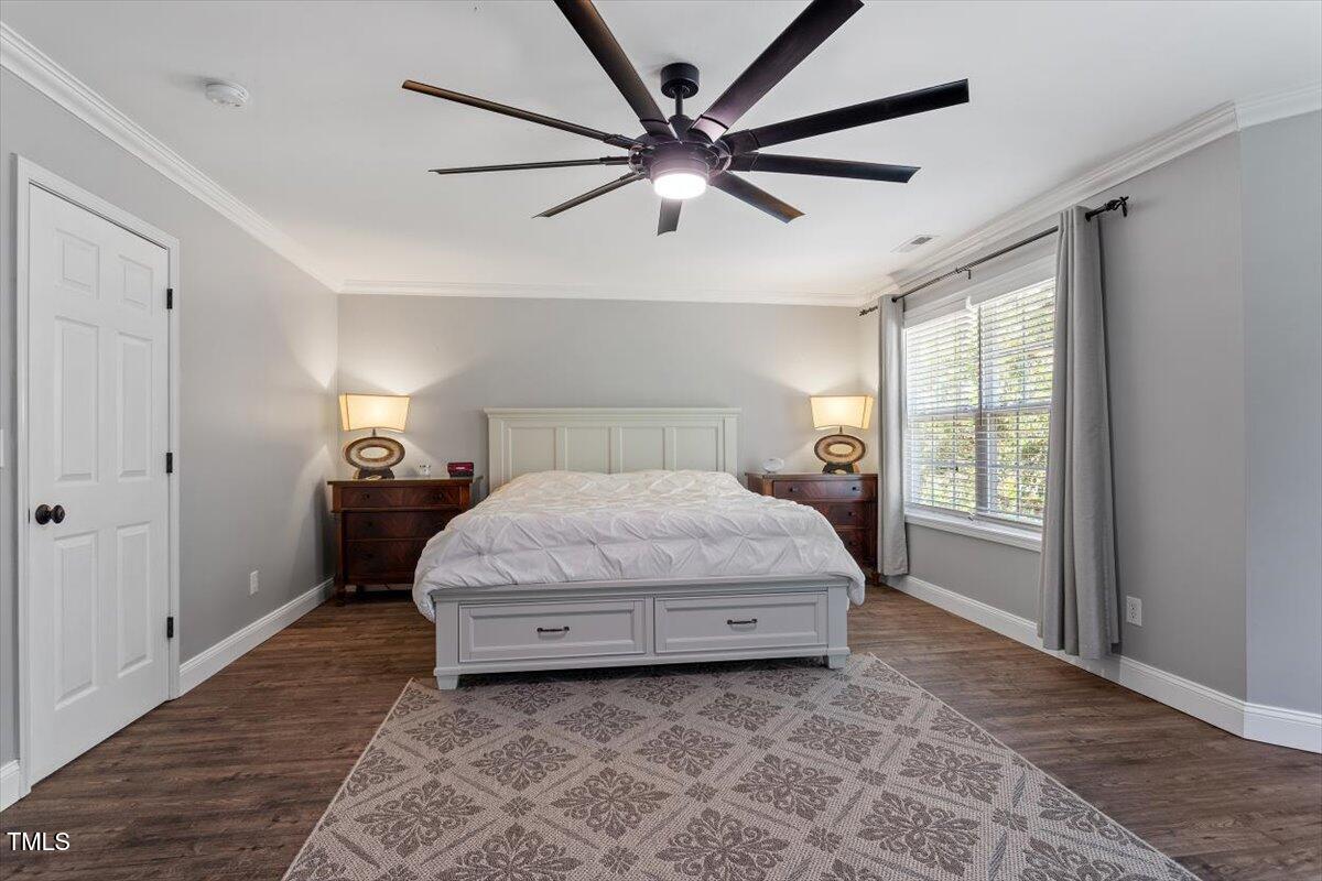 308 Mickleson Ridge Drive Raleigh, NC 27603 - Photo 25 of 51 a bedroom with a large bed and a chandelier