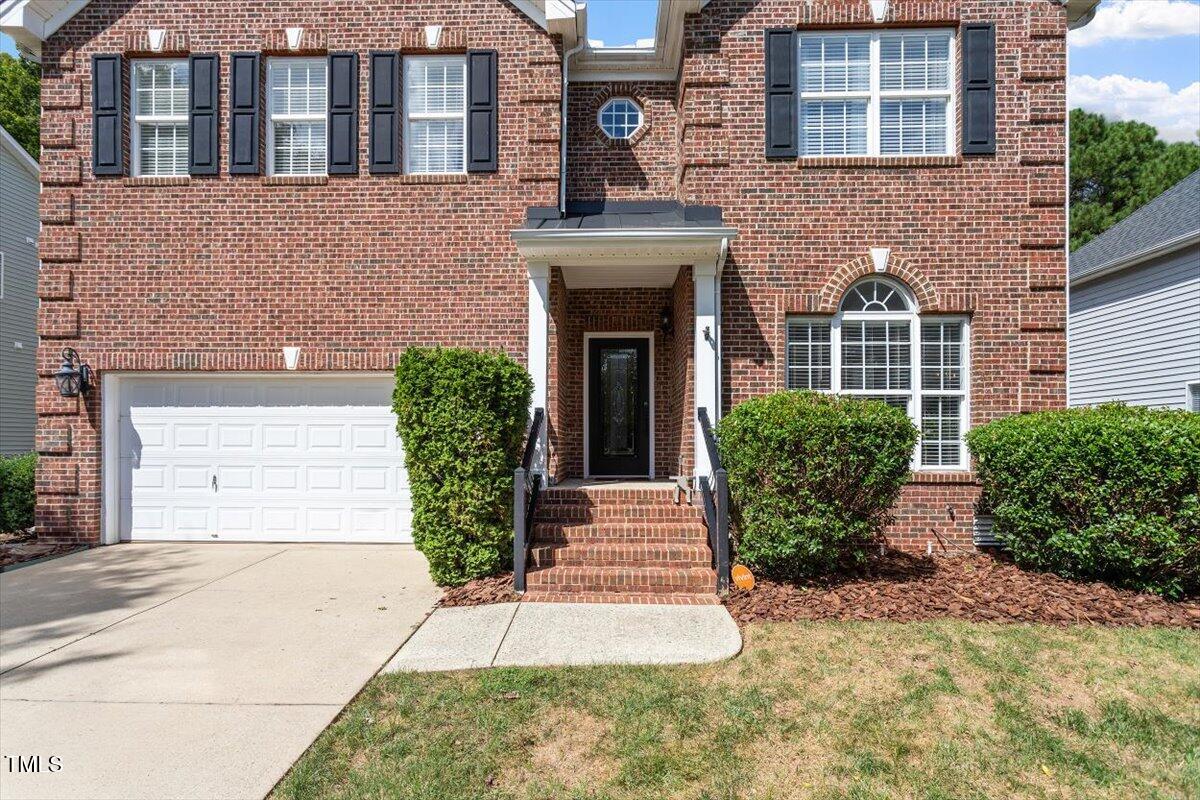 308 Mickleson Ridge Drive Raleigh, NC 27603 - Photo 3 of 51 a front view of a house with garden