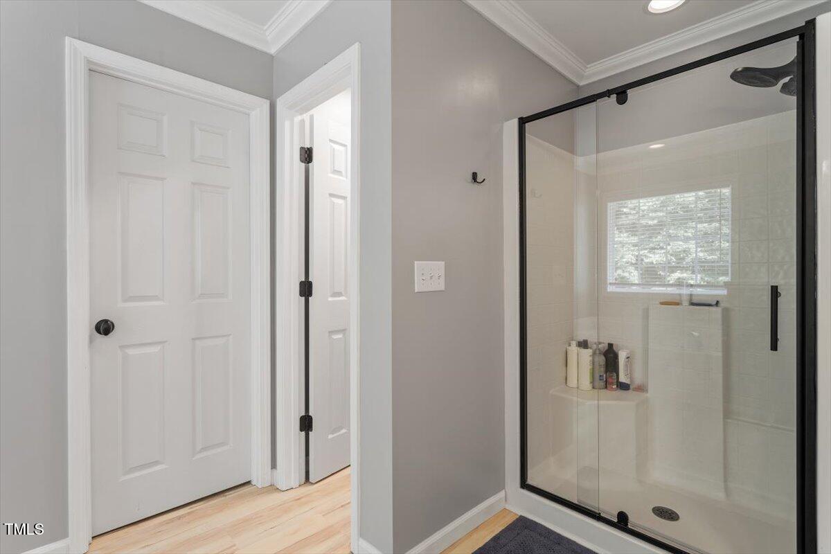 308 Mickleson Ridge Drive Raleigh, NC 27603 - Photo 31 of 51 a view of a bathroom with a glass shower door