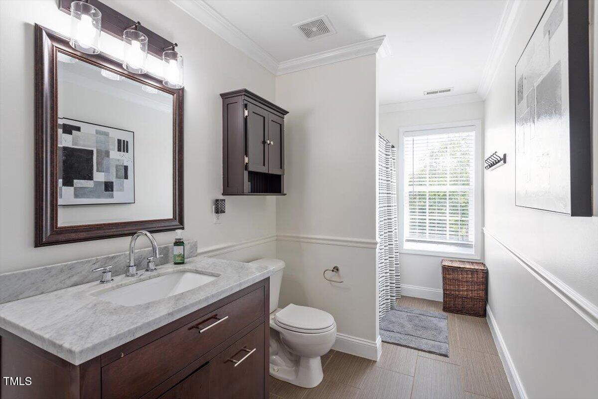308 Mickleson Ridge Drive Raleigh, NC 27603 - Photo 34 of 51 a bathroom with a granite countertop sink toilet and shower