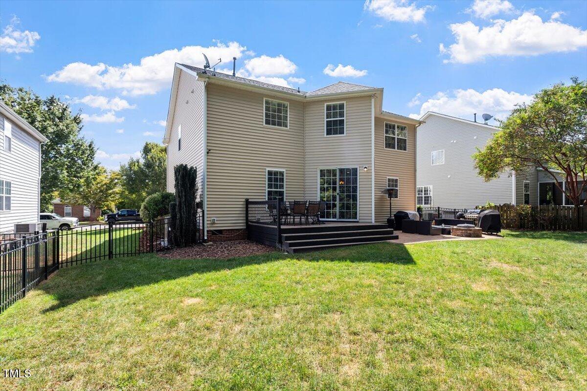 308 Mickleson Ridge Drive Raleigh, NC 27603 - Photo 38 of 51 a view of a house with a patio and a yard