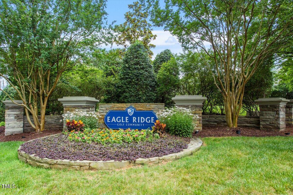 308 Mickleson Ridge Drive Raleigh, NC 27603 - Photo 41 of 51 a sign board with a garden and trees