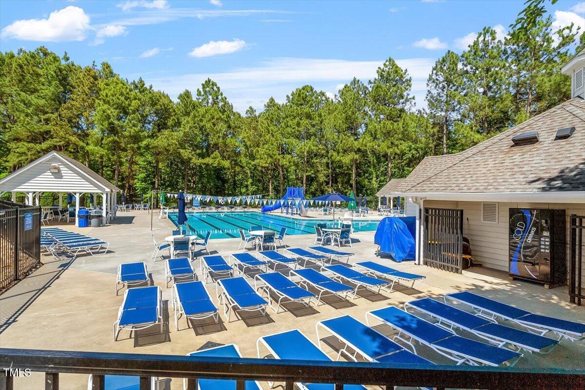 308 Mickleson Ridge Drive Raleigh, NC 27603 - Photo 49 of 51 a front view of a house with swimming pool and chairs