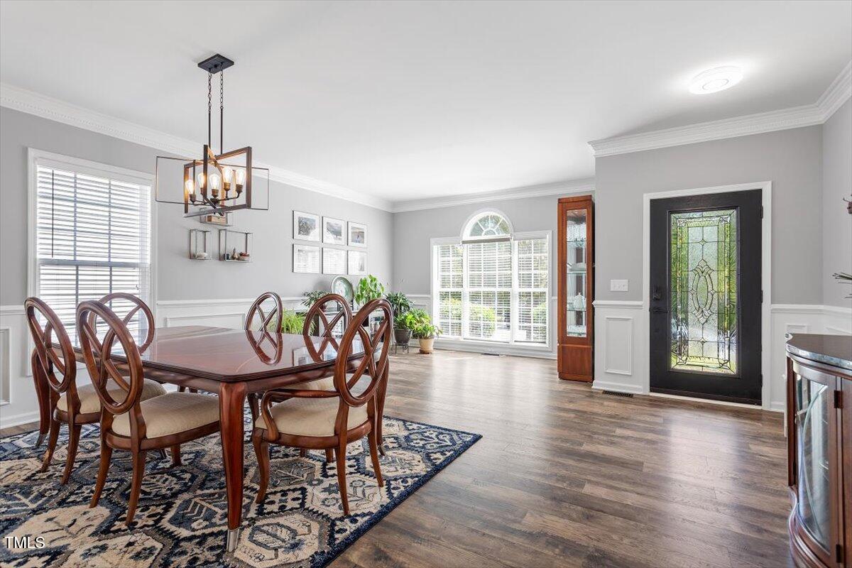 308 Mickleson Ridge Drive Raleigh, NC 27603 - Photo 5 of 51 a view of a dining room with furniture window and wooden floor