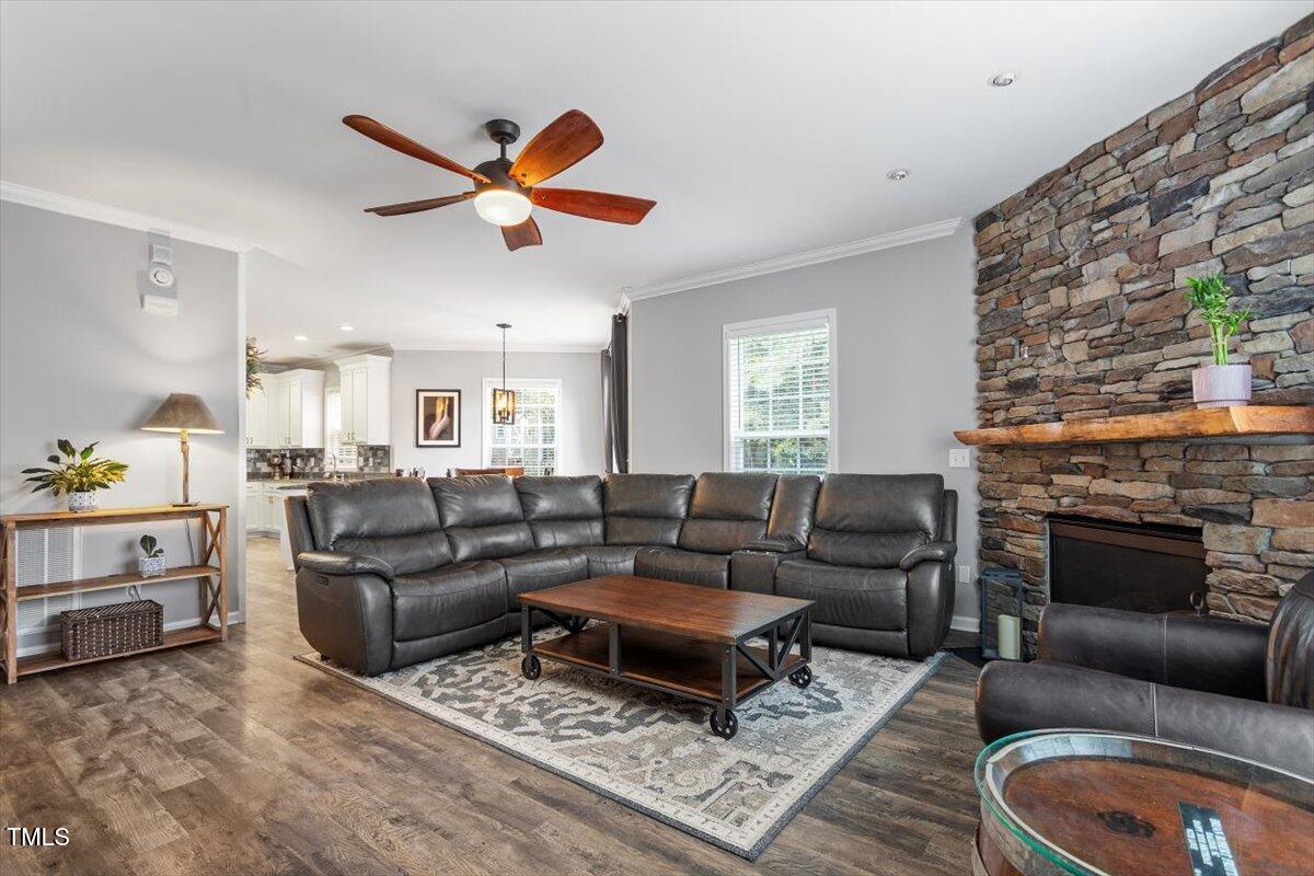 308 Mickleson Ridge Drive Raleigh, NC 27603 - Photo 10 of 51 a living room with furniture a ceiling fan and a fireplace