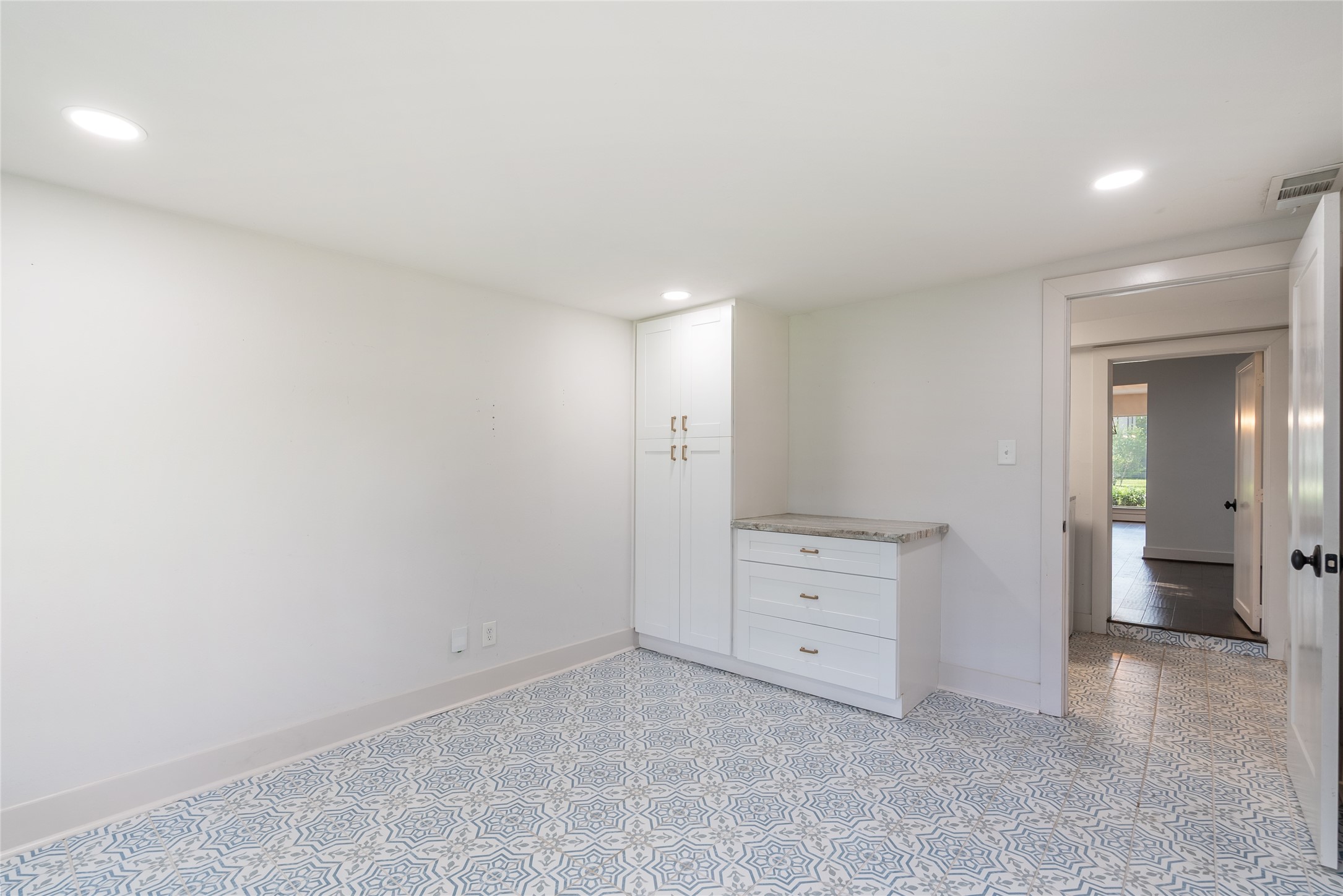 7307 Raton Street Houston, TX 77055 - Photo 17 of 23 The fourth bedroom is tucked away at the back of the home, and offers a fun tile design