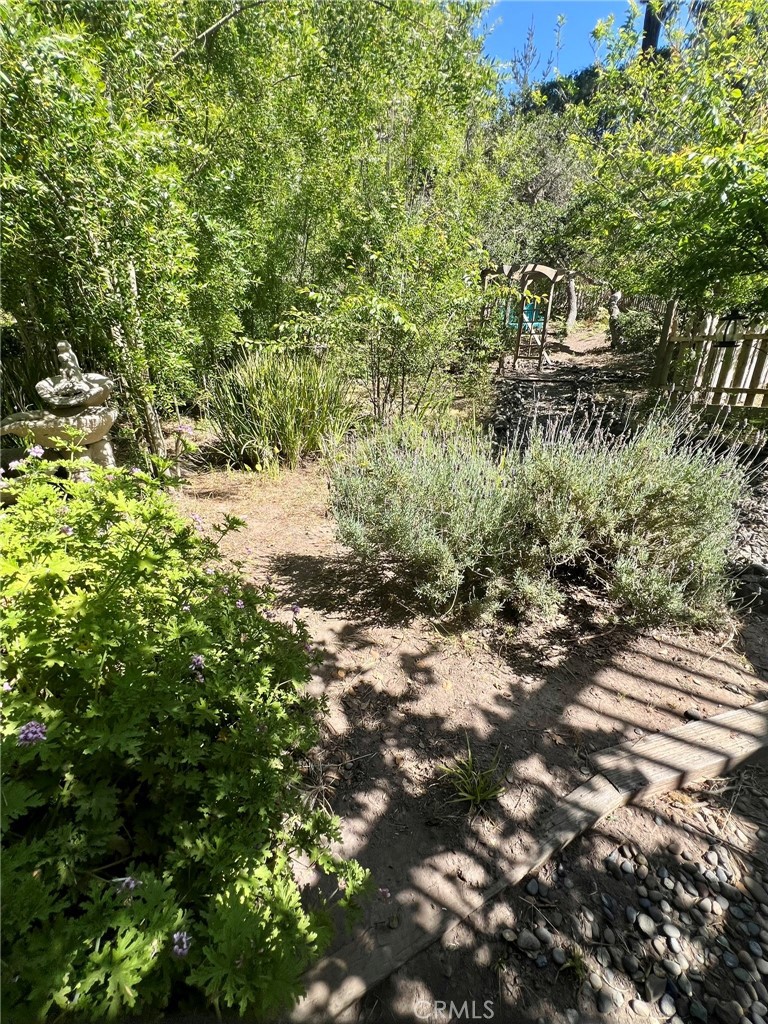 1530 Emerson Road Cambria, CA 93428 - Photo 53 of 54 Yard meanders up to another seating area.