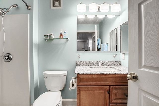 a bedroom with a bed and a television