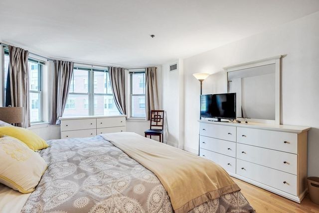 a bedroom with a bed and a lamp on table