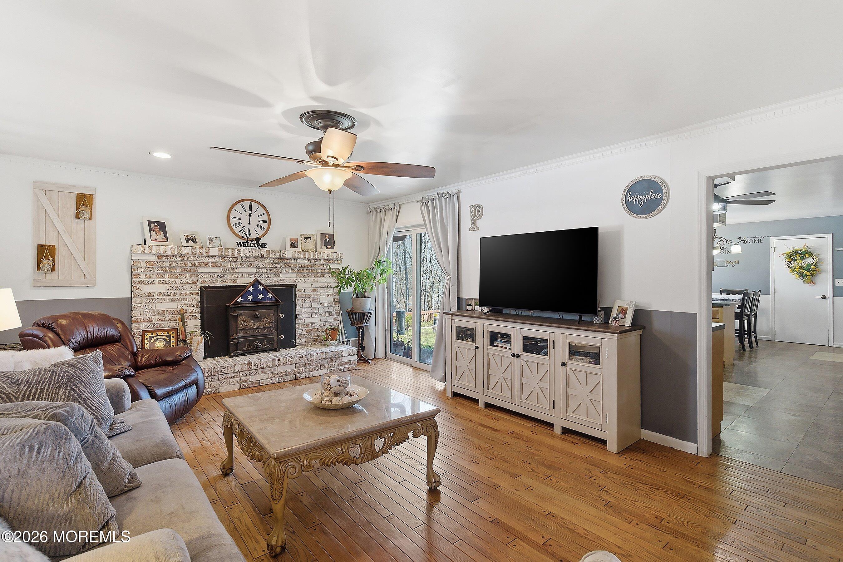 151 North Cooks Bridge Road Jackson, NJ 08527 - Photo 15 of 48 a living room with furniture a flat screen tv and a fireplace
