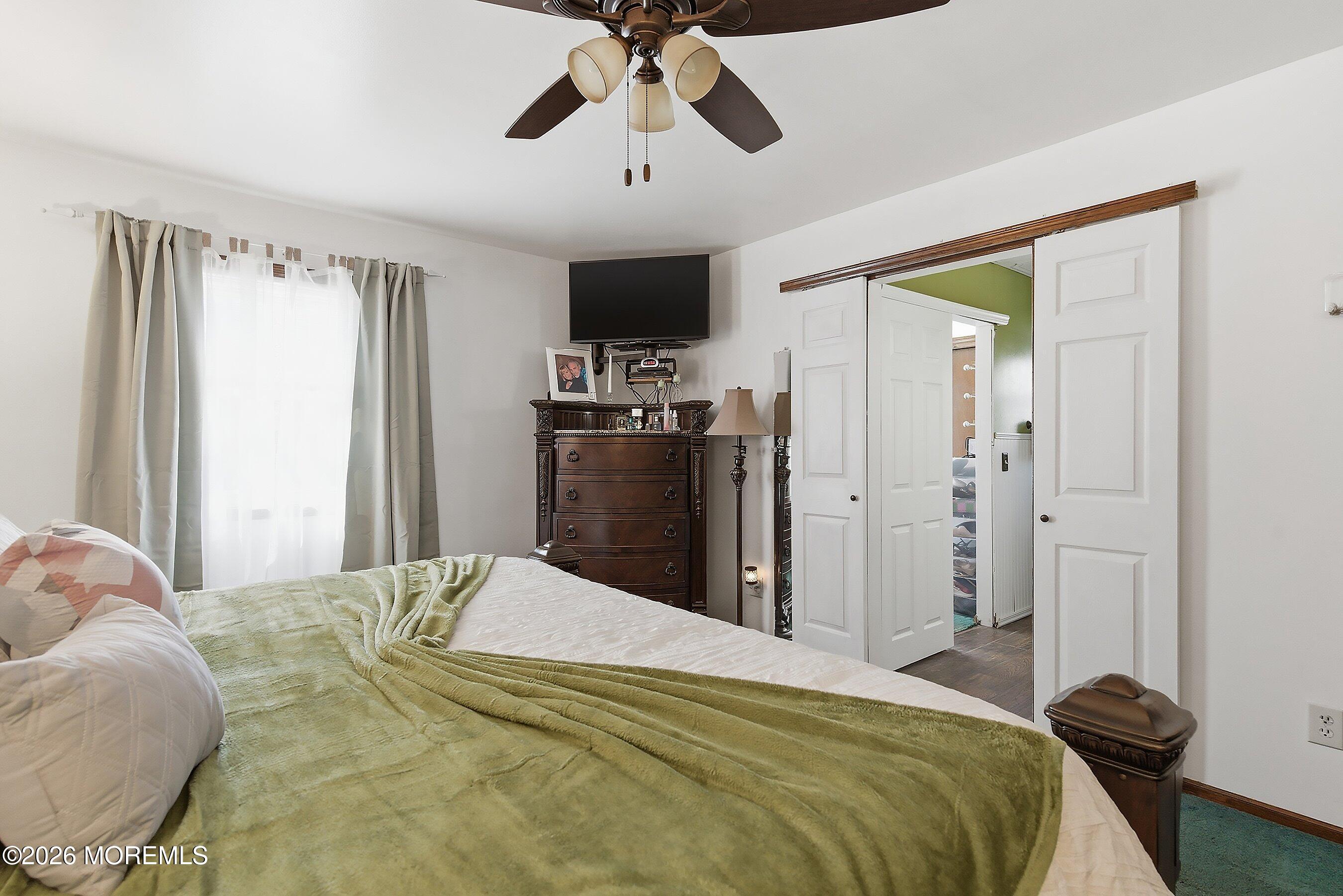 151 North Cooks Bridge Road Jackson, NJ 08527 - Photo 18 of 48 a bedroom with a bed and a chandelier