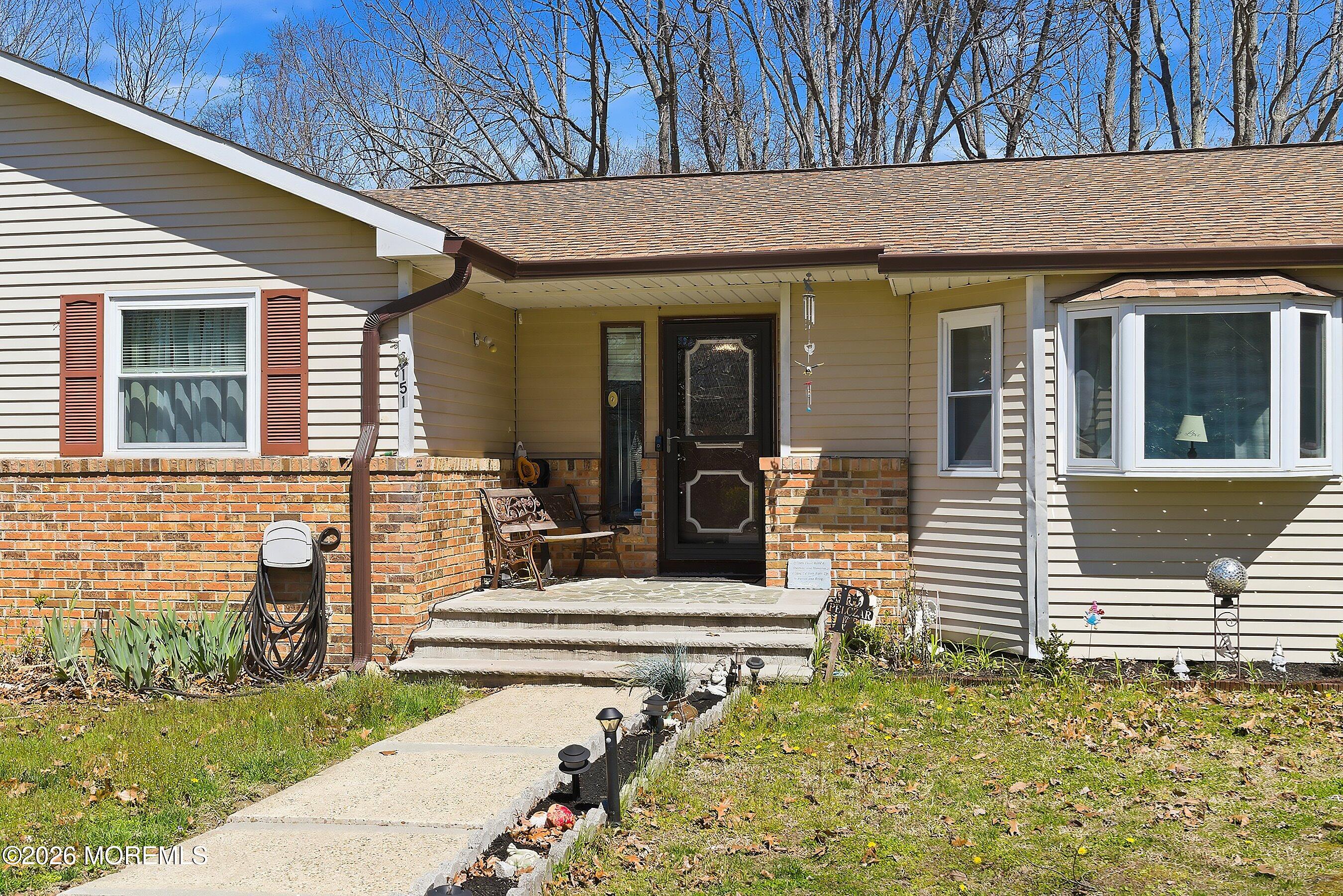 151 North Cooks Bridge Road Jackson, NJ 08527 - Photo 3 of 48 front view of a house with a bench