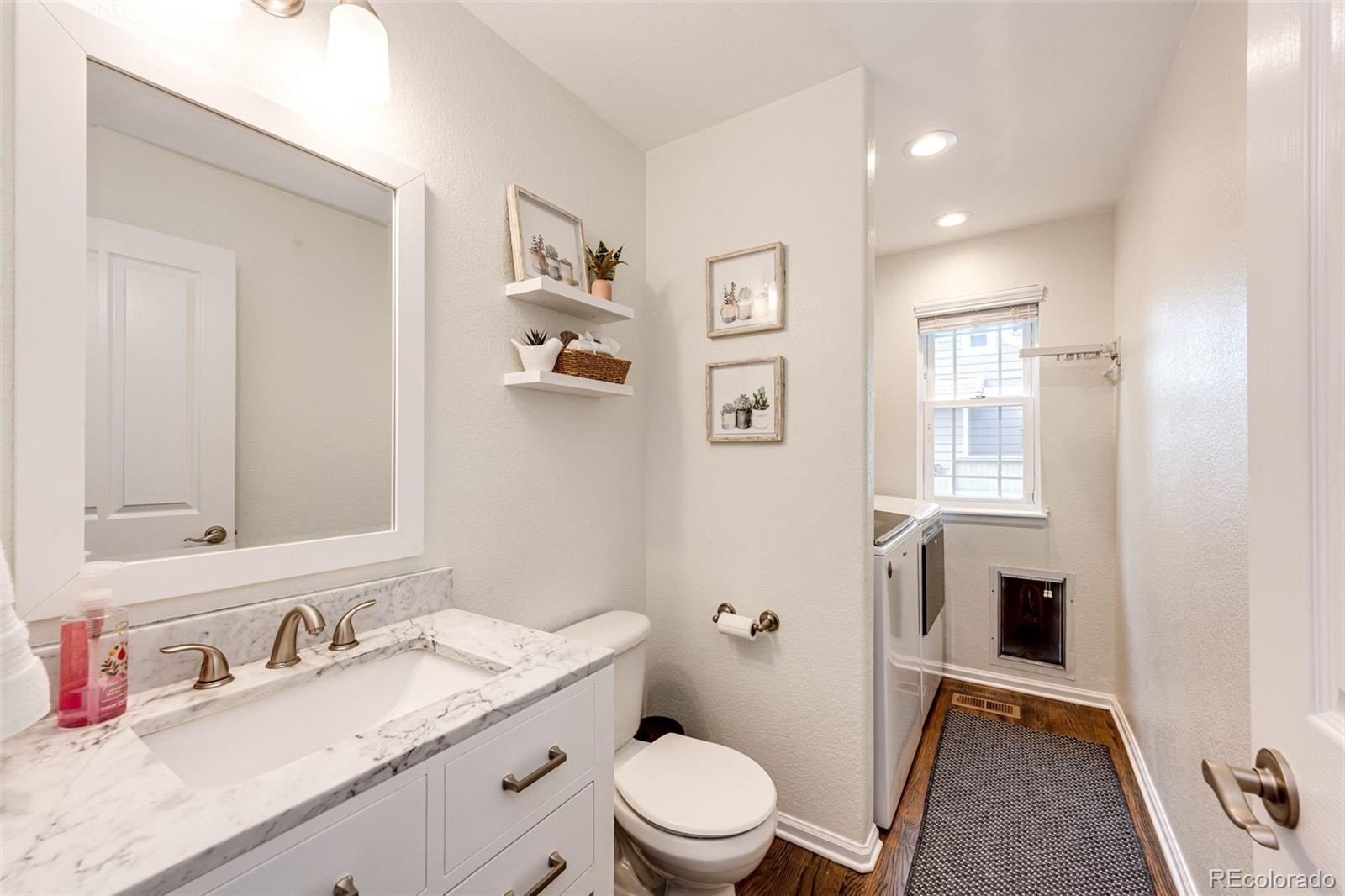 645 Springvale Road Castle Rock, CO 80104 - Photo 14 of 41 a bathroom with a granite countertop sink a toilet and a mirror