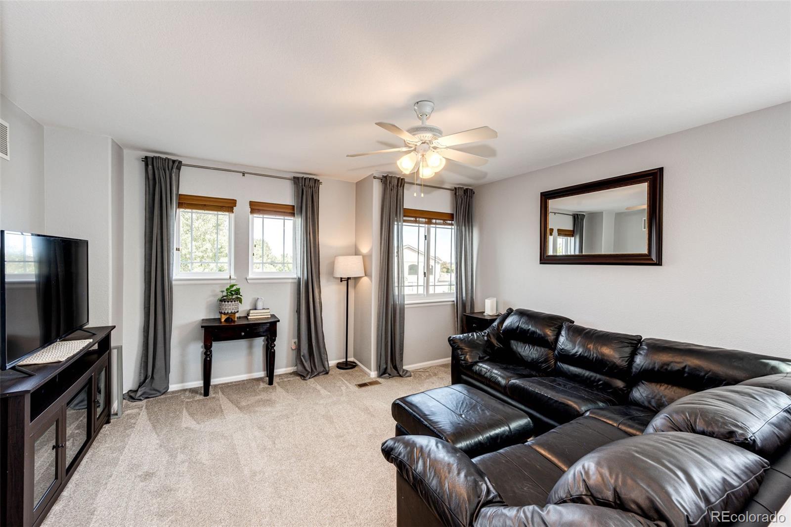 645 Springvale Road Castle Rock, CO 80104 - Photo 17 of 41 a living room with furniture ceiling fan and a window