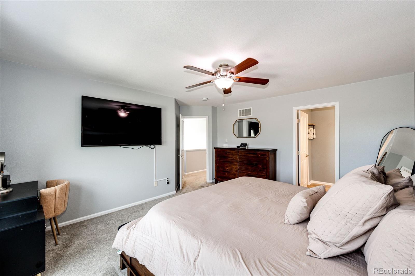 645 Springvale Road Castle Rock, CO 80104 - Photo 19 of 41 a bedroom with a bed and a flat screen tv