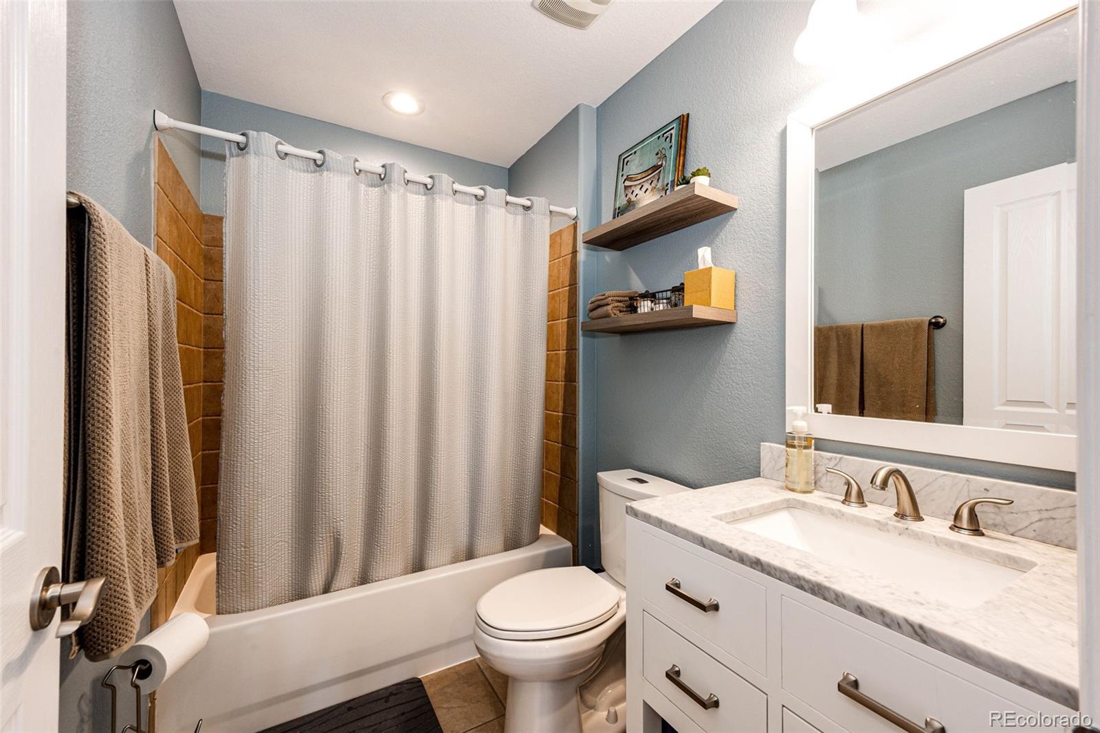 645 Springvale Road Castle Rock, CO 80104 - Photo 24 of 41 a bathroom with a granite countertop sink toilet and shower