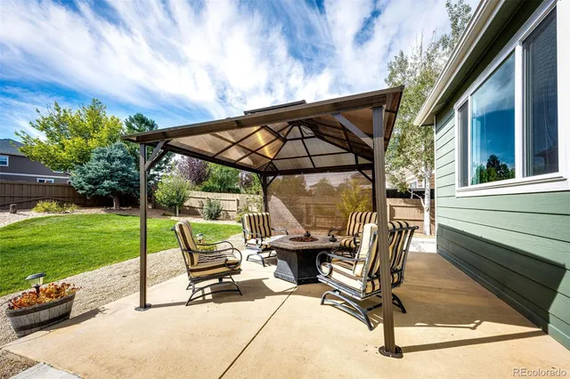 a view of backyard with sitting area