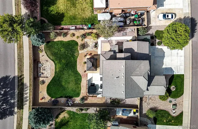 an aerial view of a house with garden space and sitting area