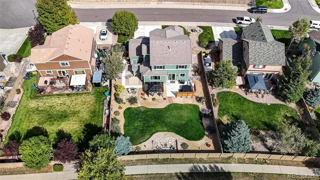 an aerial view of a house with a garden and a garage
