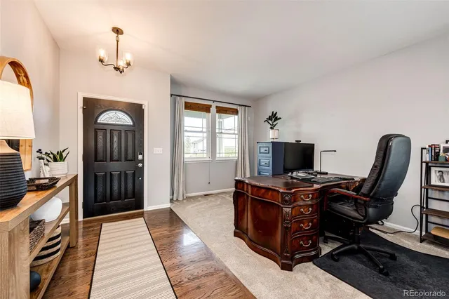 a view of a workspace with furniture and windows