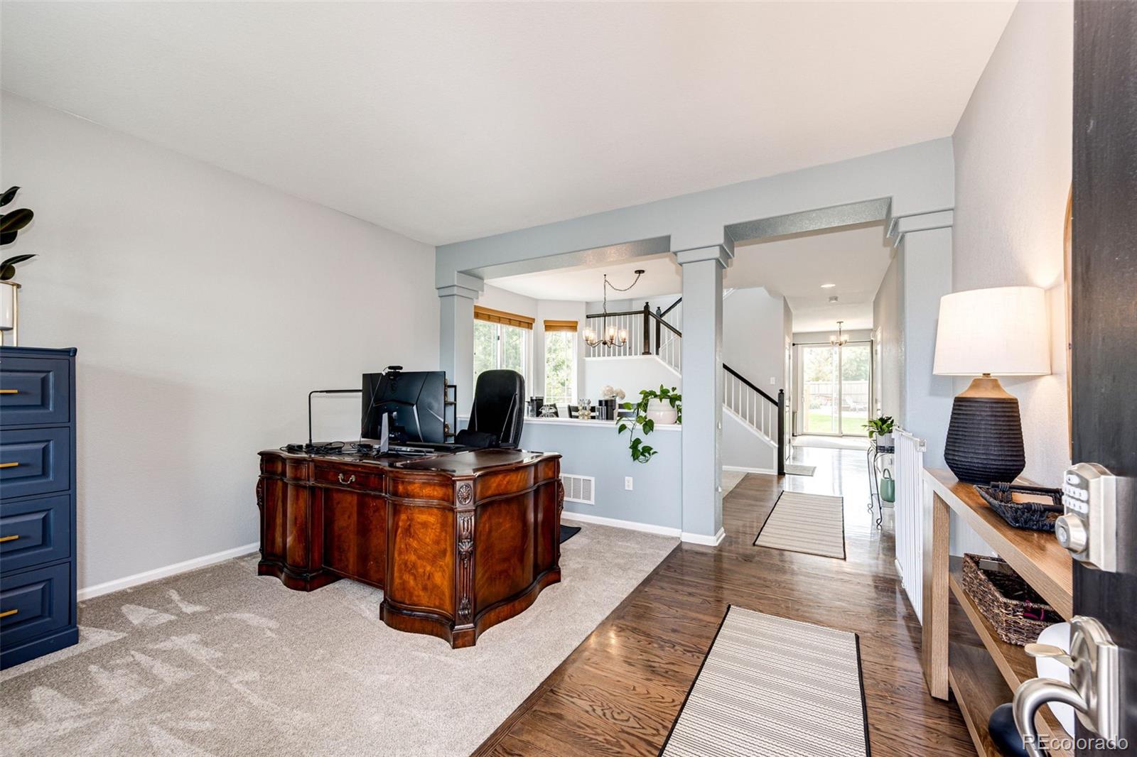 645 Springvale Road Castle Rock, CO 80104 - Photo 7 of 41 a living room with furniture and a flat screen tv