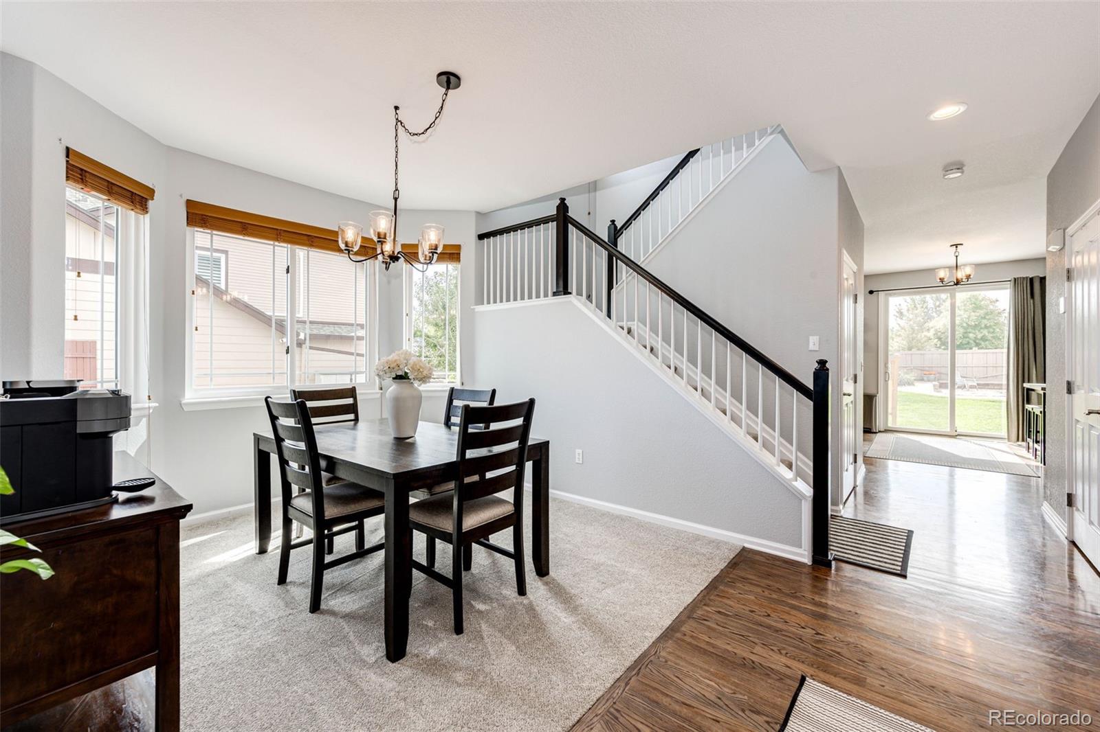 645 Springvale Road Castle Rock, CO 80104 - Photo 8 of 41 a view of a dining room with furniture window and wooden floor