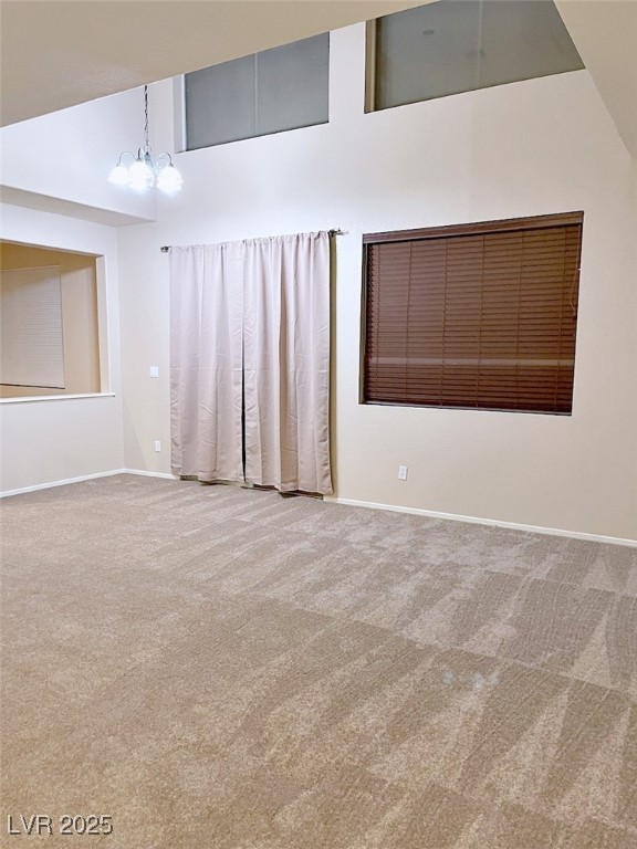7640 Sierra Paseo Lane Las Vegas, NV 89128 - Photo 17 of 49 Carpeted room featuring a chandelier and baseboards