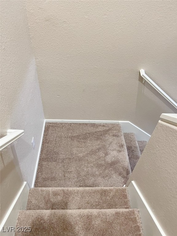7640 Sierra Paseo Lane Las Vegas, NV 89128 - Photo 26 of 49 Stairs featuring a textured wall and carpet floors