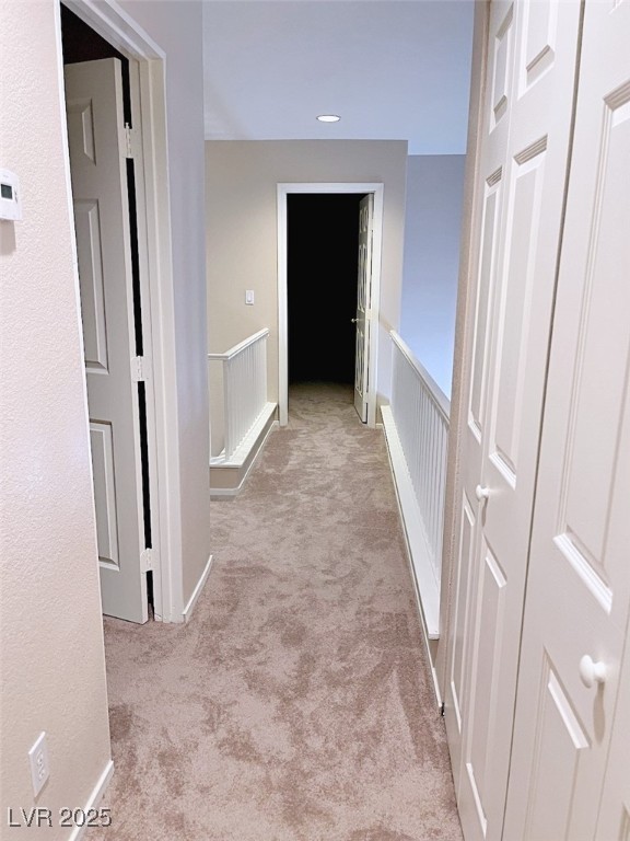 7640 Sierra Paseo Lane Las Vegas, NV 89128 - Photo 28 of 49 Hall with light colored carpet, an upstairs landing, and recessed lighting