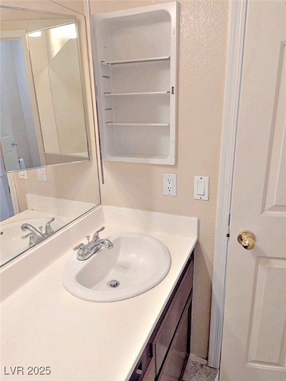 7640 Sierra Paseo Lane Las Vegas, NV 89128 - Photo 42 of 49 Bathroom with vanity and a textured wall