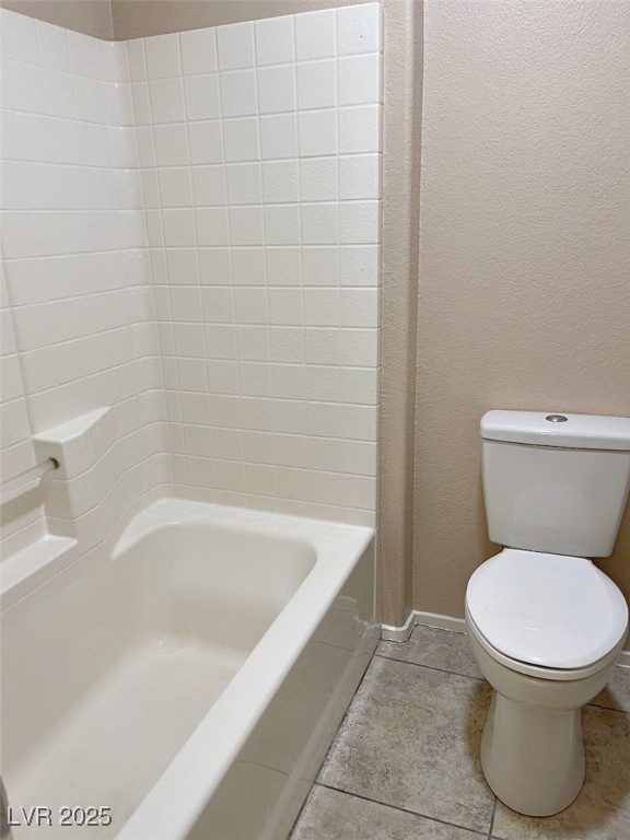 7640 Sierra Paseo Lane Las Vegas, NV 89128 - Photo 44 of 49 Full bathroom featuring light tile patterned flooring, bathtub / shower combination, and a textured wall