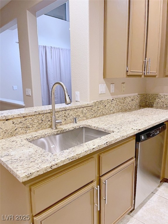 7640 Sierra Paseo Lane Las Vegas, NV 89128 - Photo 6 of 49 Kitchen featuring light stone counters, cream cabinets, stainless steel dishwasher, and light tile patterned floors