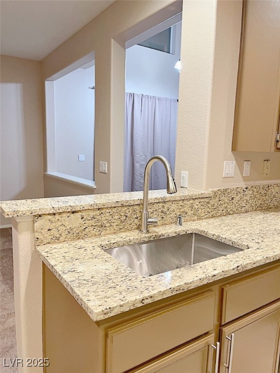 7640 Sierra Paseo Lane Las Vegas, NV 89128 - Photo 7 of 49 Kitchen with light stone counters and a peninsula