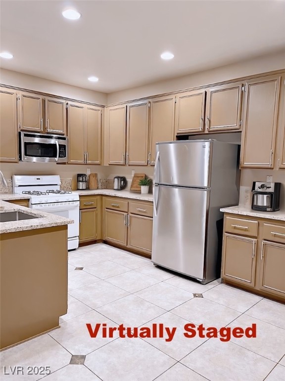 7640 Sierra Paseo Lane Las Vegas, NV 89128 - Photo 9 of 49 Kitchen featuring appliances with stainless steel finishes, recessed lighting, light tile patterned floors, and light stone countertops
