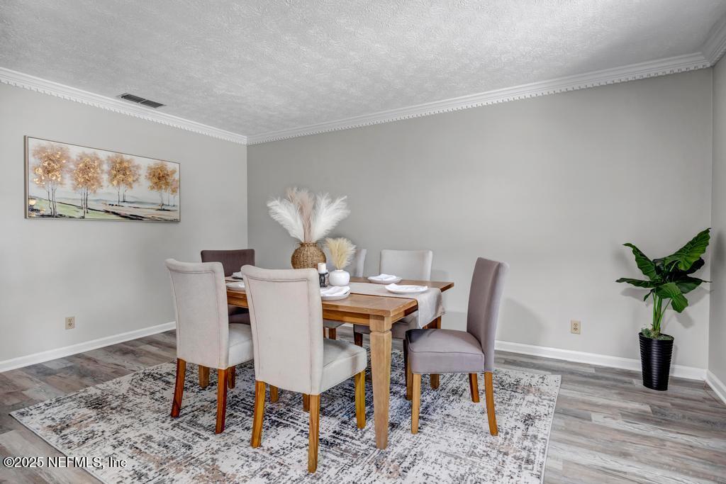 4448 Charter Point Boulevard Jacksonville, FL 32277 - Photo 11 of 47 a view of a dining room with furniture window and wooden floor