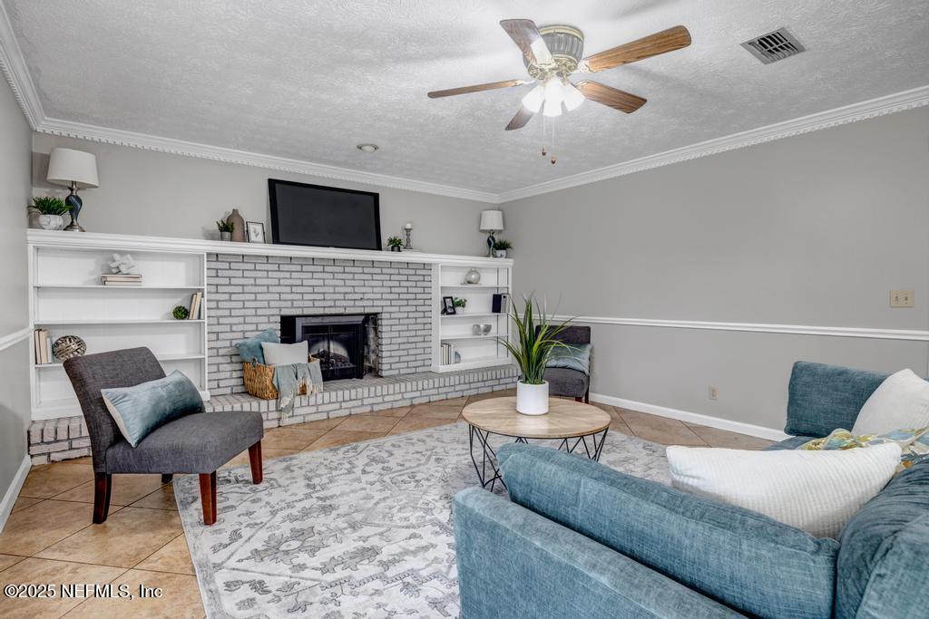 4448 Charter Point Boulevard Jacksonville, FL 32277 - Photo 13 of 47 a living room with furniture and a fireplace