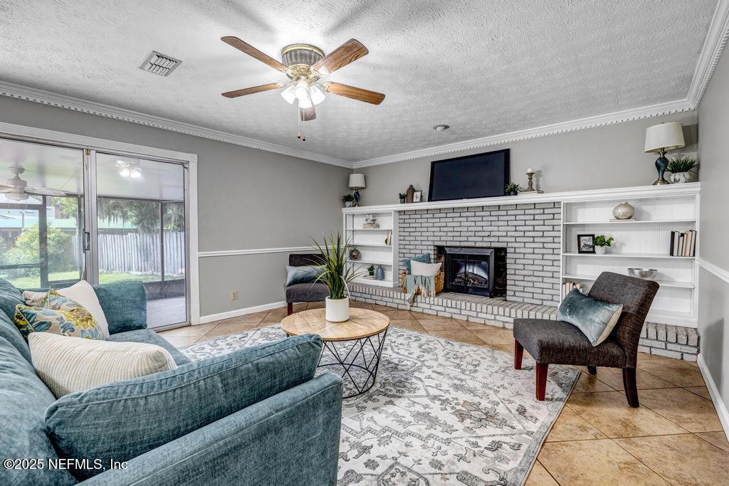 4448 Charter Point Boulevard Jacksonville, FL 32277 - Photo 14 of 47 a living room with furniture and a fireplace