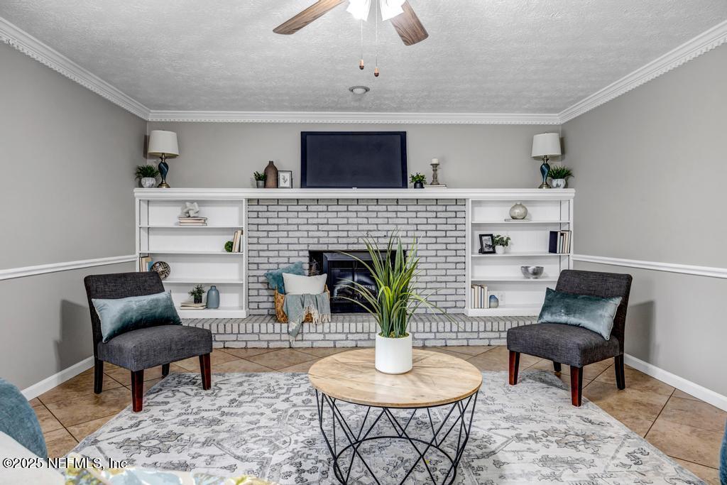 4448 Charter Point Boulevard Jacksonville, FL 32277 - Photo 15 of 47 a living room with furniture and a fireplace
