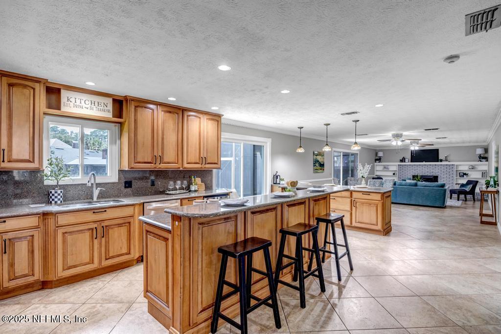 4448 Charter Point Boulevard Jacksonville, FL 32277 - Photo 22 of 47 a kitchen with a sink and chairs
